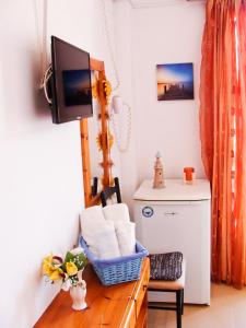 a living room with a tv and a chair at PANSION KONSTANTINOS in Skiathos