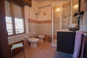a bathroom with a toilet and a sink at B&B Cardedu in Cardedu