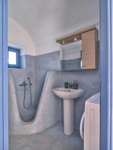 a bathroom with a sink and a bath tub with a sink at Leticia Villa with pool with amazing sea views, Paros in Márpissa