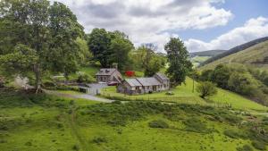 an aerial view of a house in a green field at Glyn Mawr Barn in Bala