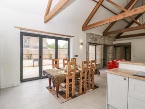 a kitchen and dining room with a table and chairs at The Old Stables in Gillingham