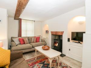 a living room with a couch and a fireplace at 7 Church Lane in Lymington