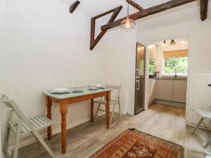 a kitchen and dining room with a table and chairs at 7 Church Lane in Lymington