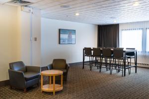 a waiting room with a table and chairs at Sternwheeler Hotel & Conference Centre, Trademark by Wyndham in Whitehorse