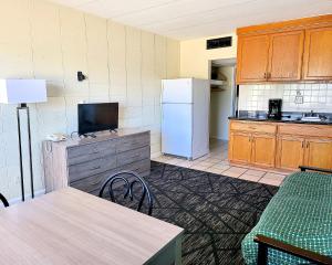 a kitchen with a refrigerator and a table and chairs at Beach Carousel Virginia Beach in Virginia Beach