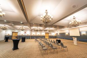 a conference room with chairs and a podium in the middle at Sternwheeler Hotel & Conference Centre, Trademark by Wyndham in Whitehorse