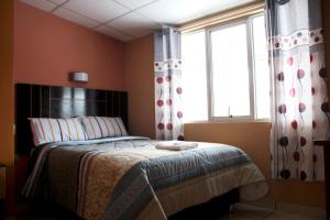 a bedroom with a bed and a window at Hotel Monthañas Cajamarca in Cajamarca +22 photos