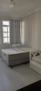 Katil atau katil-katil dalam bilik di Pitangueiras Kitnetes