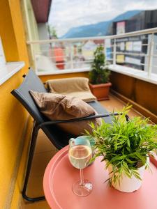 a glass of wine on a table on a balcony at Apartment Mira in Ružomberok