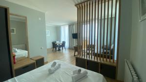 a hotel room with a bed and a mirror at Green Hills Batumi in Batumi