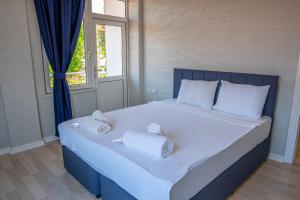 a blue bed with towels on it in a room at İpek Apart in Antalya