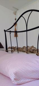 a bed with a black frame with a white mattress at Sardinia82 Sunsetplace in Palau