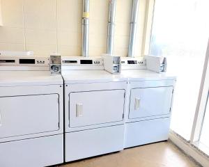 a group of white washing machines sitting in a room at Beach Carousel Virginia Beach in Virginia Beach