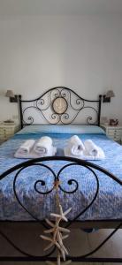 a bed with towels and a starfish on it at Sardinia82 Sunsetplace in Palau +58 photos