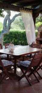 a wooden table and chairs on a patio at Sardinia82 Sunsetplace in Palau