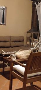 a living room with a couch and a chair at Sardinia82 Sunsetplace in Palau