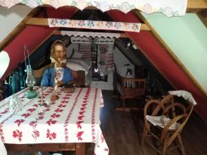a dining room with a table in a attic at Umjetnička etno kuća Luka in Podravske Sesvete