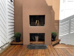 a fireplace in a living room with two potted plants at The yellow door in Stavanger