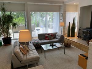 a living room with a couch and a table at Forest by the Sea Rentals in Merville