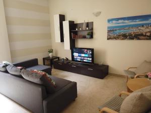 A television and/or entertainment centre at Assarotti Centre Apartment