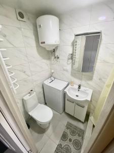 a white bathroom with a toilet and a sink at BYSmartHouse in Kyiv +17 photos