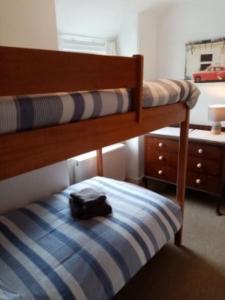 a backpack sitting on top of a bunk bed at Bridge View Victorian Townhouse Central Aberystwyth Sleeps 6 in Aberystwyth