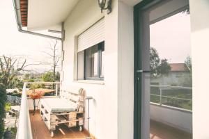 a balcony with a bench and a window at Villa Clementina in Barcelos +28 photos