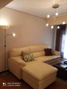 a living room with a couch and a lamp at Guimar in Avilés