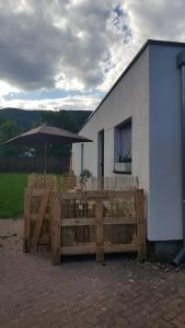a wooden fence and an umbrella in front of a building at Savannah in Muhlbach-sur-Munster