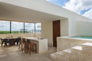 a kitchen and dining area of a house with a swimming pool at New Tulum Luxury 2BRBath with Private Pool Heart of La Veleta in Tulum