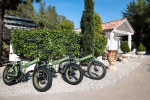 four bikes parked in a row in front of a house at Campo Di Fiori, Maisons de Charme in Calvi