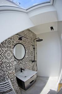 a bathroom with a sink and a mirror at Ełk apartamenty in Ełk