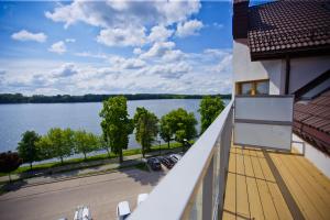 a balcony with a view of a lake at Ełk apartamenty in Ełk