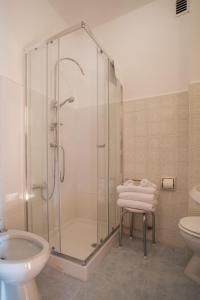 a bathroom with a shower and a toilet and a sink at Villa Angela Olympic Garda Lake in Toscolano Maderno