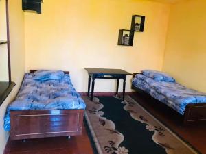 a room with two beds and a desk in it at Dzoragyugh B&B in Dzoragyugh
