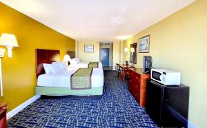 a hotel room with two beds and a tv at Ocean Resort in Virginia Beach