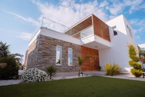 a house with a balcony on top of it at Villa Aquamarine in Paphos City