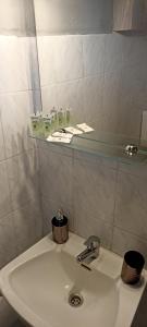 a bathroom sink with a glass shelf above it at Poseidon room's Vourvourou in Vourvourou