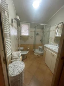 a bathroom with a shower and a sink and a toilet at Casa vacanze Sant'Antioco in SantʼAntìoco