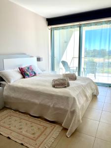 a bedroom with a large bed and a large window at NEW STUNNING OCEAN APRT IN "OASIS MAR" Wi-Fi in Portimão +41 photos