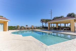 a swimming pool in the middle of a resort at South Beach Club 205, 3 Bedrooms, Sleeps 6, Ocean View, 2nd Floor, Elevator in Flagler Beach