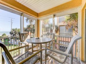 a balcony with a table and chairs and the ocean at South Beach Club 205, 3 Bedrooms, Sleeps 6, Ocean View, 2nd Floor, Elevator in Flagler Beach