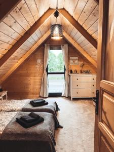 two beds in a room with an attic at Slope House (Domek na Skarpie) Lipowa in Lipowa