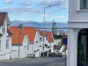 a town with white houses and a street with mountains at The yellow door in Stavanger