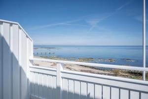 a balcony with a view of the ocean at Melsted Badehotel in Gudhjem
