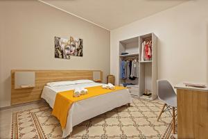 ein Schlafzimmer mit einem Bett mit einer gelben Decke in der Unterkunft nearporto in Trapani