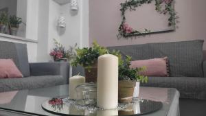 a living room with a table with candles on it at Lavender Home in Volos