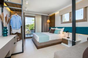 a bedroom with a bed and a balcony at Elegant Corner Superior Rooms & Apartments in Limenaria