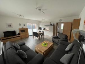 a living room with a couch and a table at Am Wangermeer 38a in Wangerland