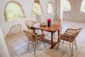 a dining room with a wooden table and chairs at Villa Angelos in Ermioni +41 photos